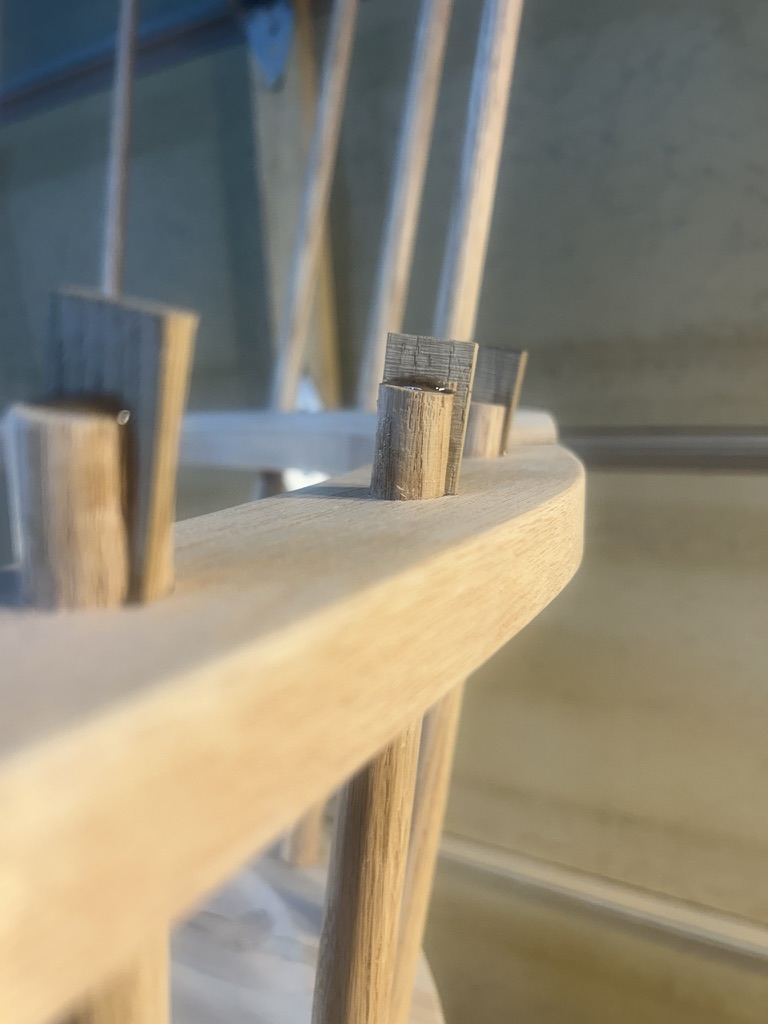 Close-up of wedged sticks coming through the arm