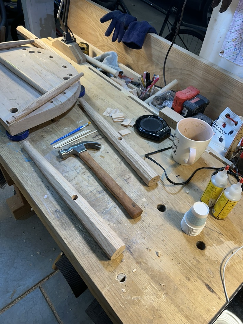Workbench with a seat blank, legs and a hammer