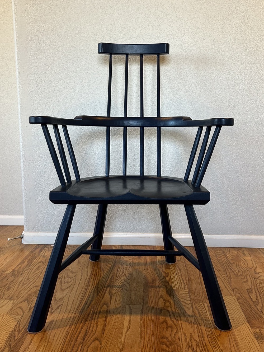 A navy painted American stick chair, seen from the front