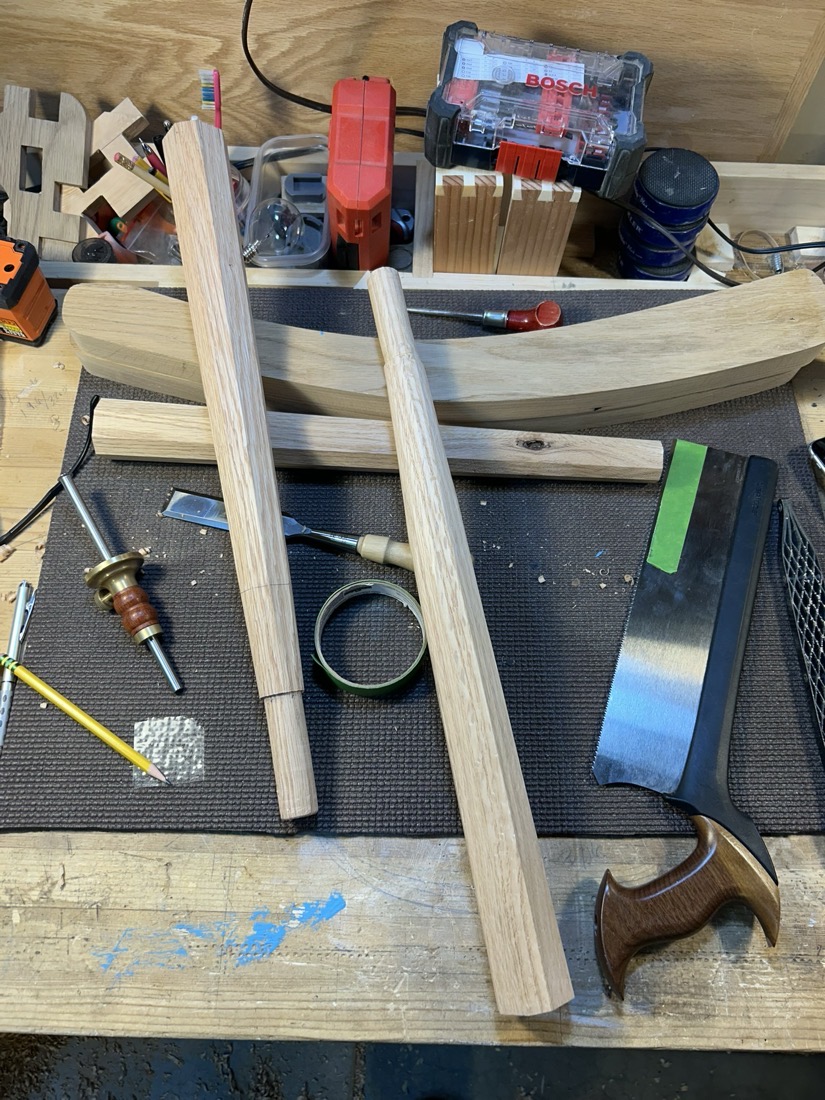 Shaped legs and an arm blank on the bench beside hand tools
