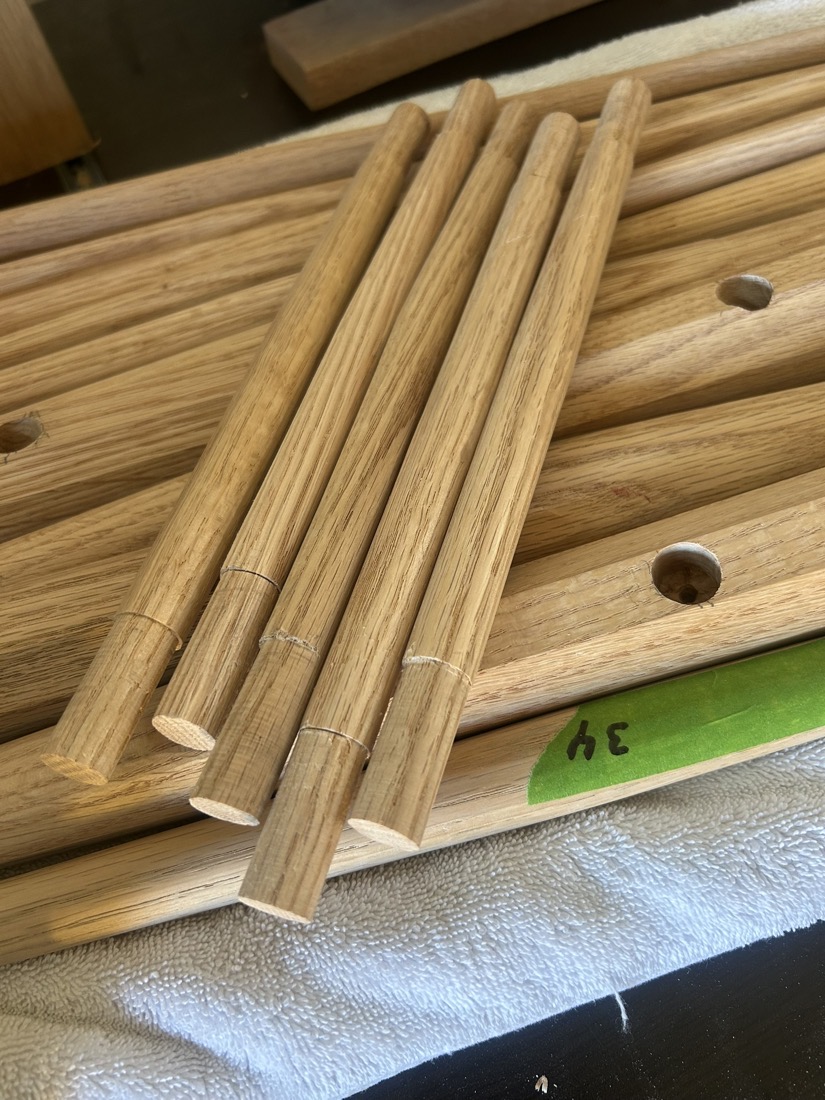 Oak sticks with tenons cut, laid on a board
